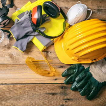 A close up of PPE on a wooden table.