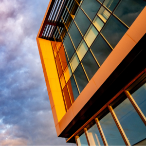 An close up of a building on the NCSU campus. Purple and blue clouds are in the background.