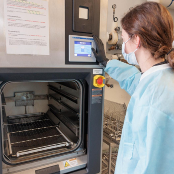 A scientist using an autoclave.