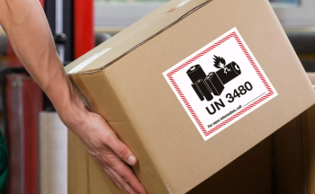 Close up of a person handling a box containing dangerous materials.