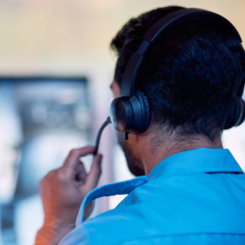 A worker adjusts their headset microphone.
