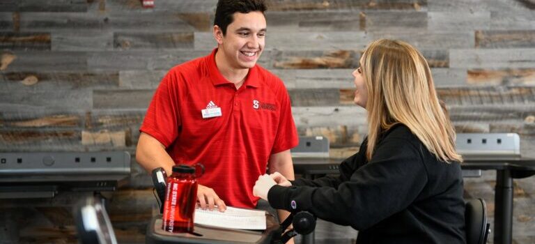 A helpful team member talks with staff